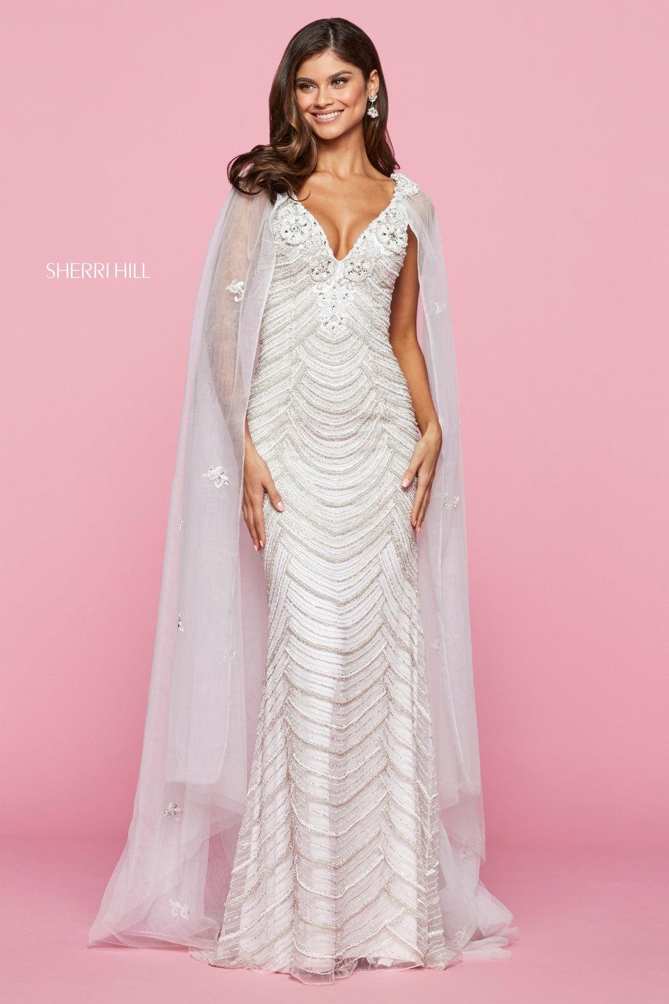 sherri hill Fitted beaded gown with embellished V neckline and organza cape with embroidered detailing