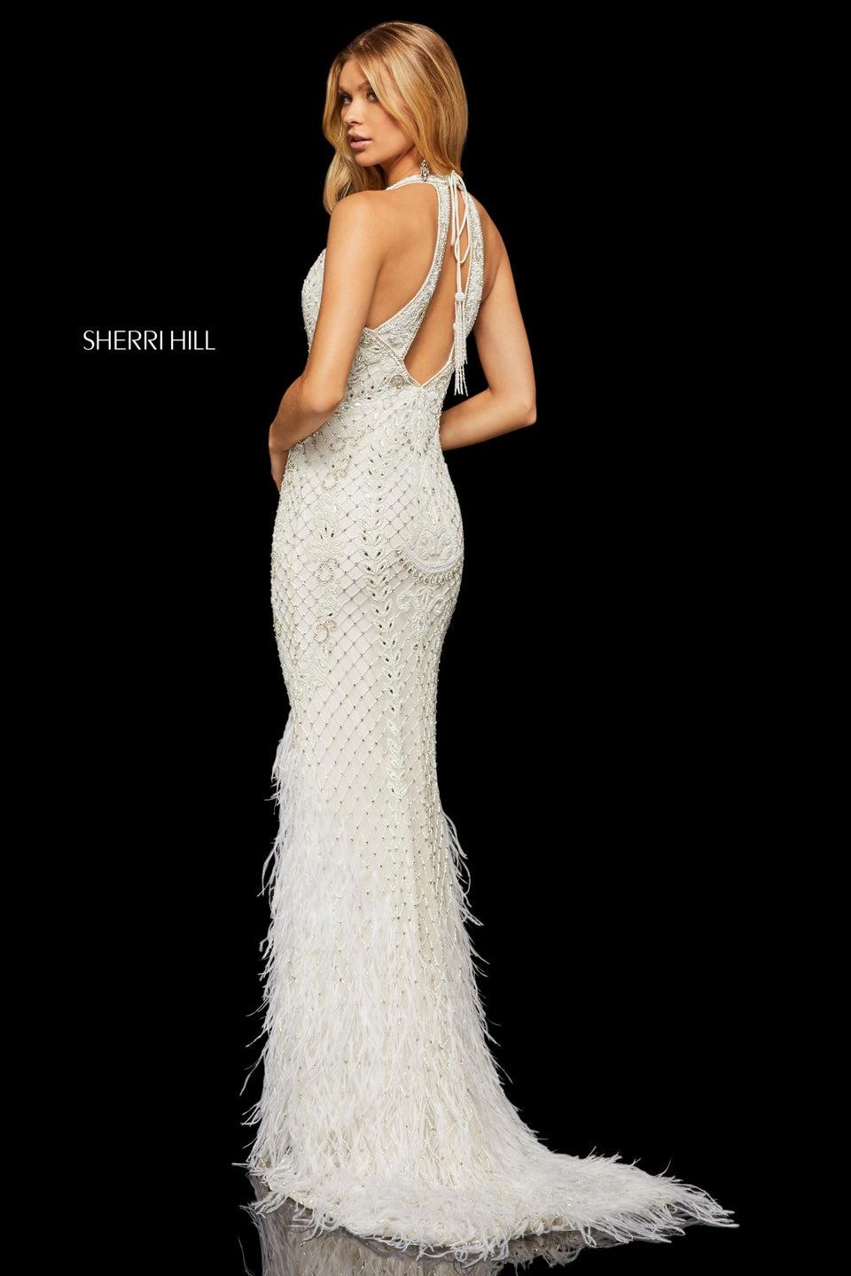 sherri hill Fully beaded gown with a deep-V neckline and keyhole back with feather details on bottom of the skirt