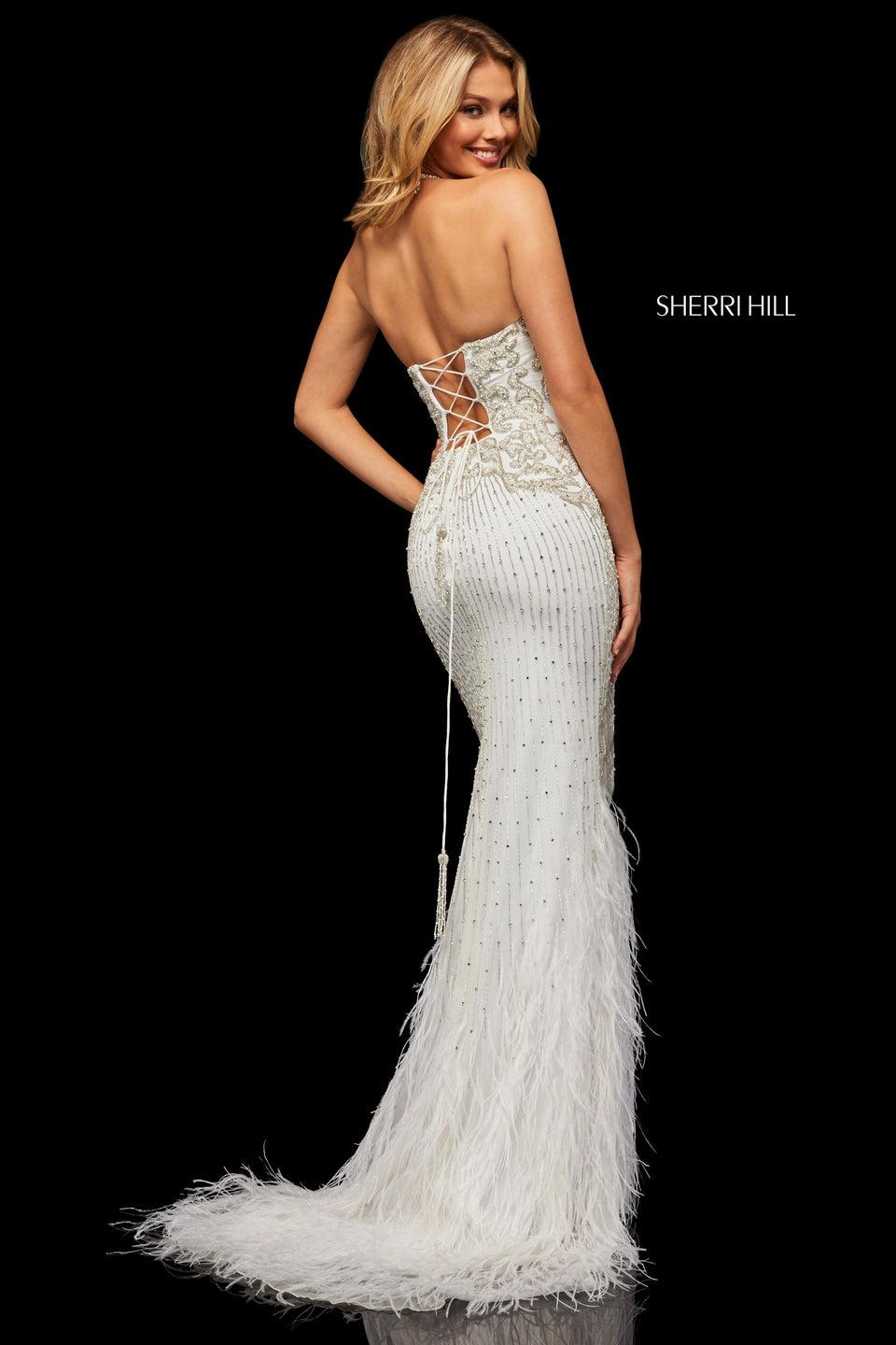 sherri hill Fully beaded gown with a halter neck and lace up back with feather details on bottom of the skirt