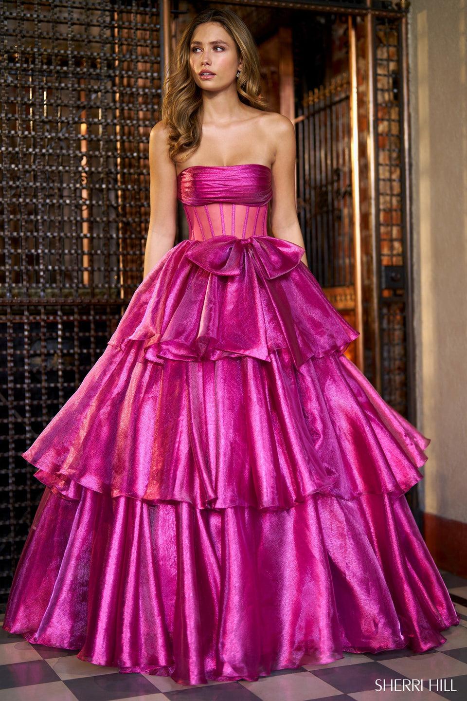 Sherri Hill Lamé Strapless Ballgown With Sheer Corset Bodice Bow Embellishment And Ruffle Skirt With Slit