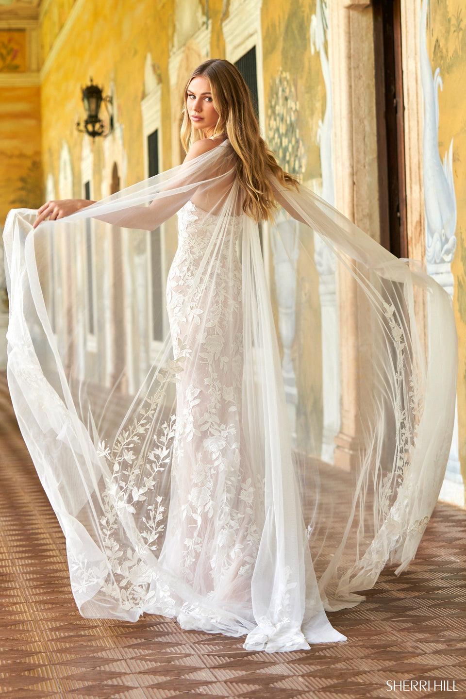 Sherri Hill Leaf Lace Halter Neckline Fitted Gown With Deep V-Neckline Bodice And Tulle Cape