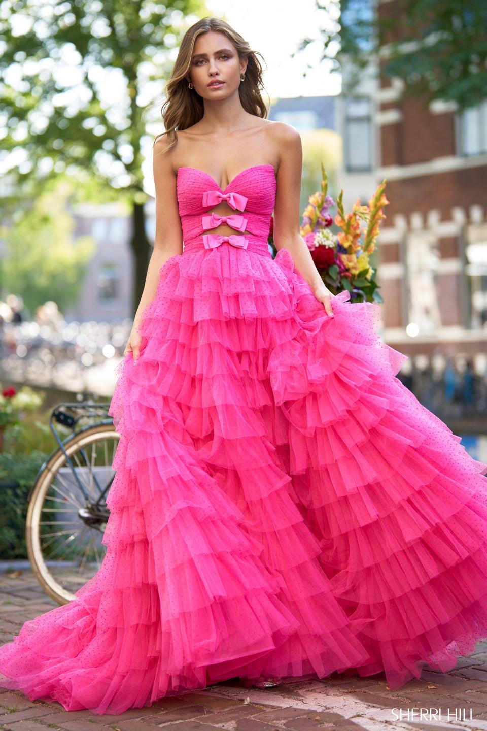 sherri hill Strapless polka dot ball gown with key holes bows and a tulle ruffle skirt slit