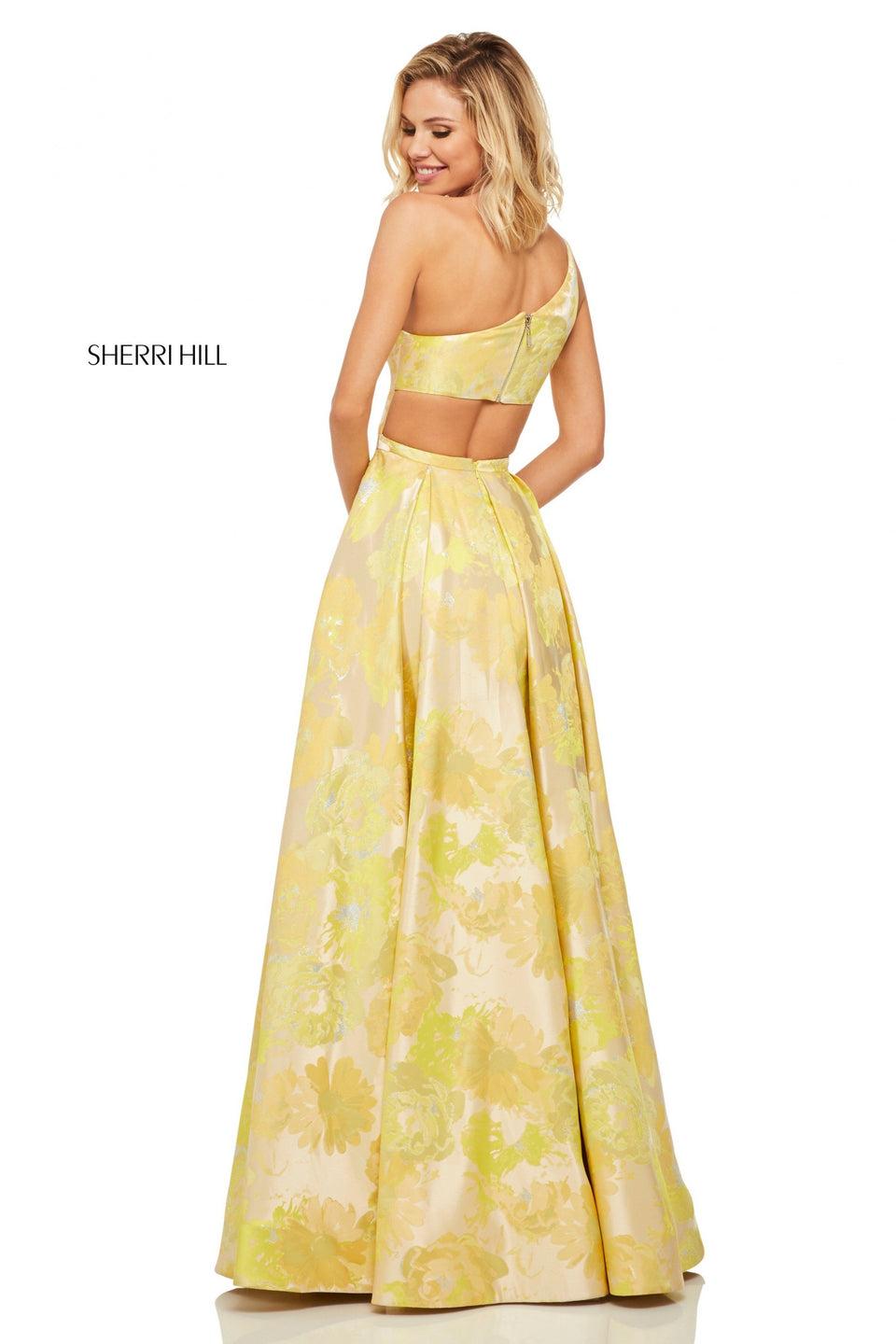 Sherri Hill Yellow Brocade One Shoulder Gown With A Ruffle Front Slit And Cut Out Back